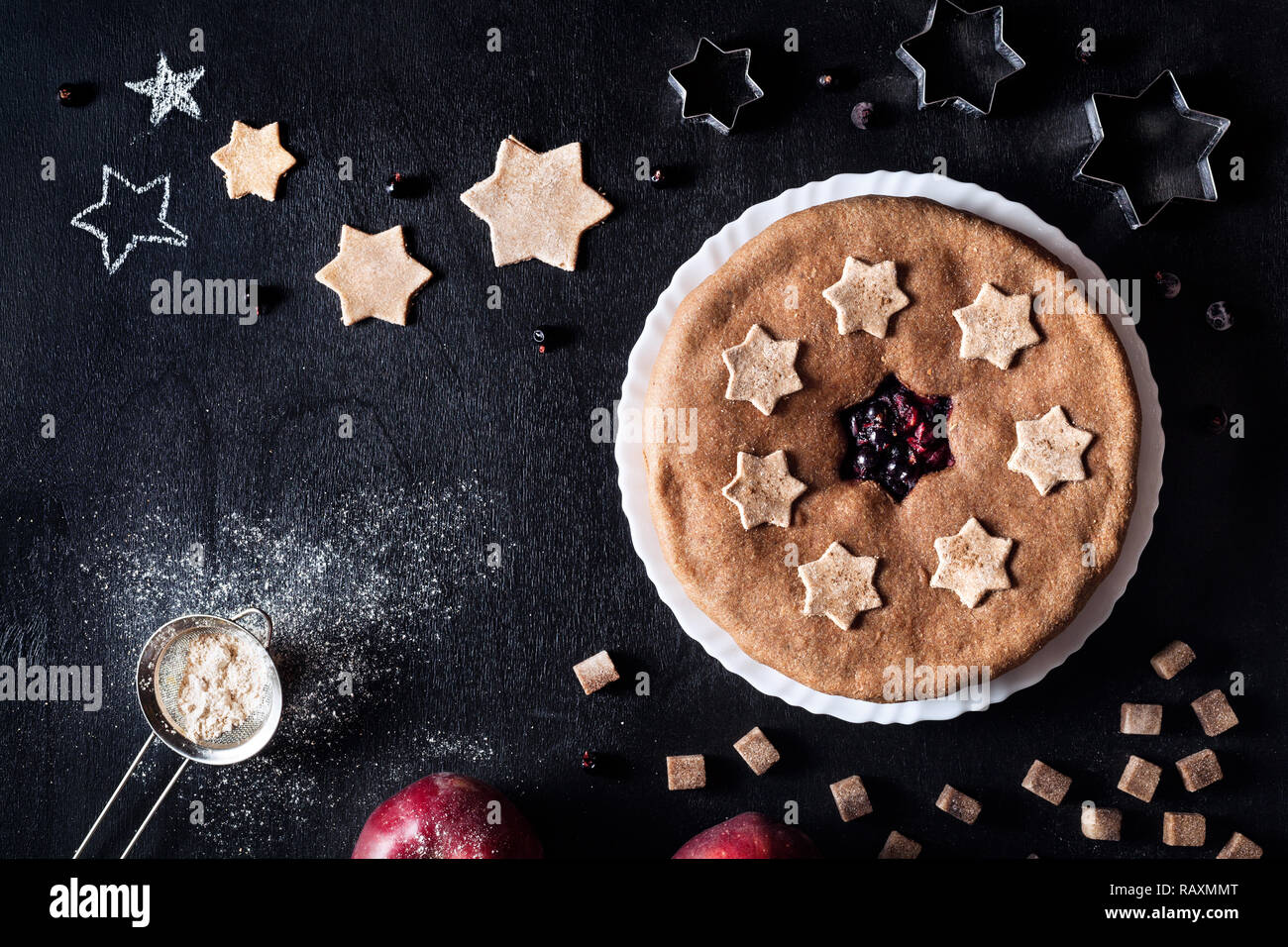 Vegan homemade pie from currant and apples on black background Stock Photo
