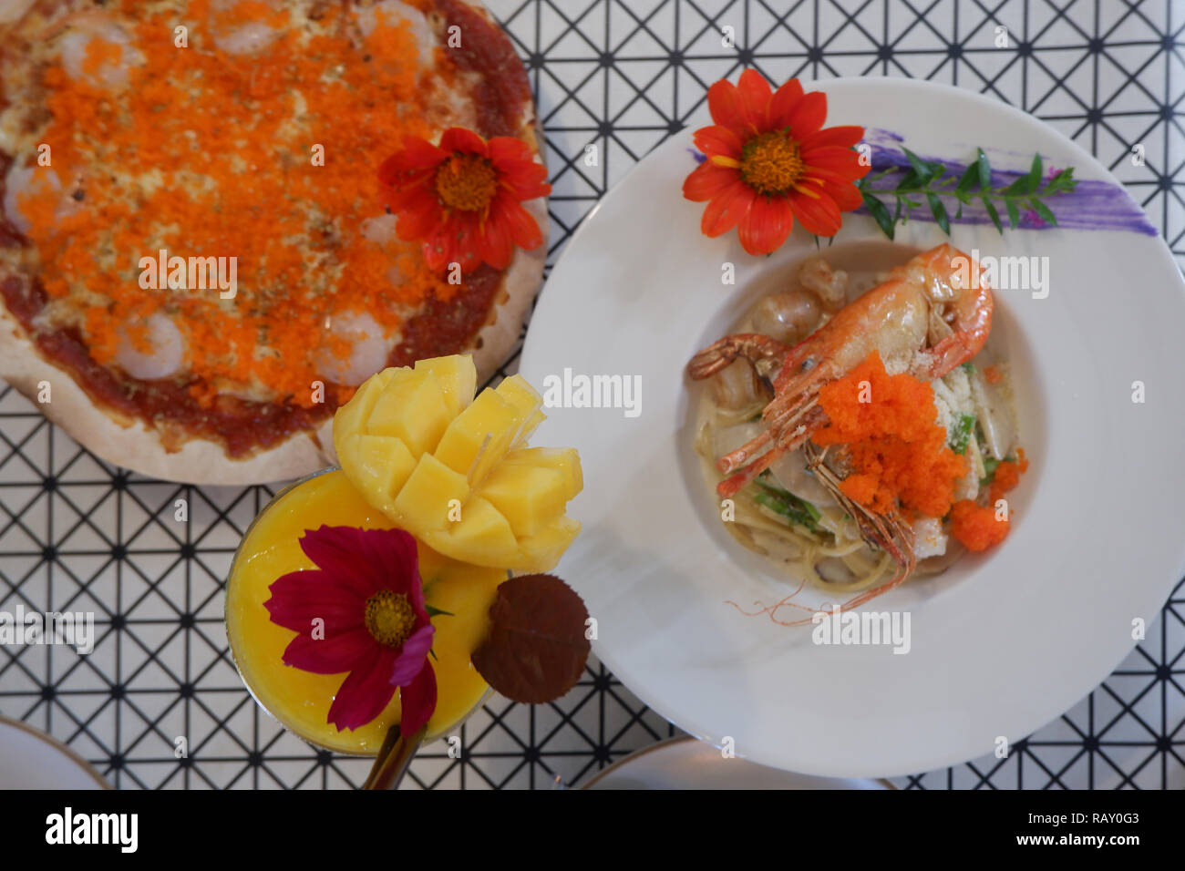 top view of beautiful setting of fresh food, pizza, pasta, mango shake