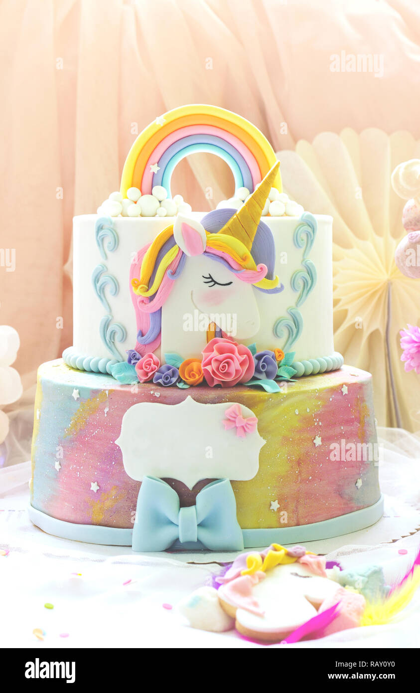 Little girl's birthday party; dessert table with unicorn cake, cake-pops, sugar cookies and birthday decoration Stock Photo