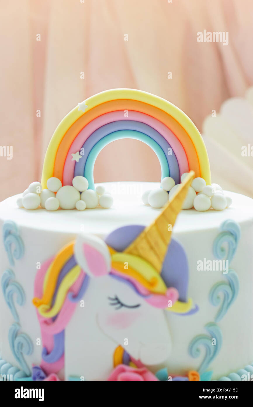Detail of a birthday unicorn cake - focus on rainbow topper Stock Photo