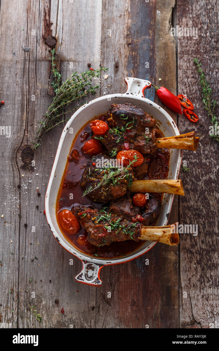 Lamb shank braised in tomato sauce, top view. Stock Photo