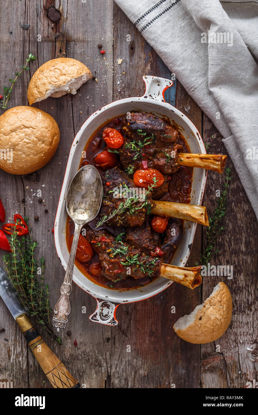 Lamb shank braised in tomato sauce, top view. Stock Photo