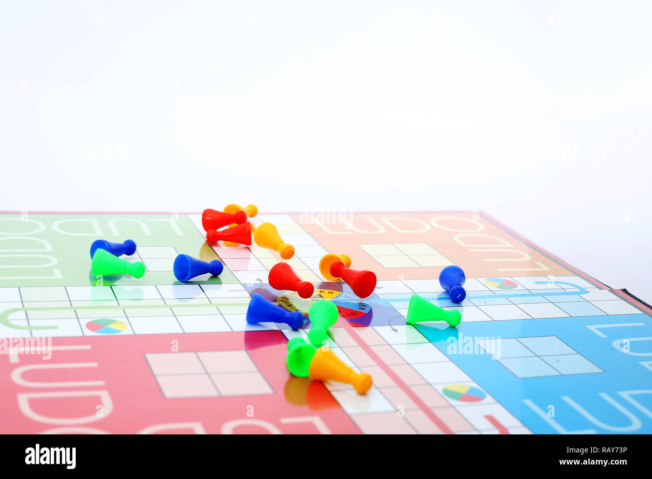 Different colors ludo tokens on the ludo game. Stock Photo