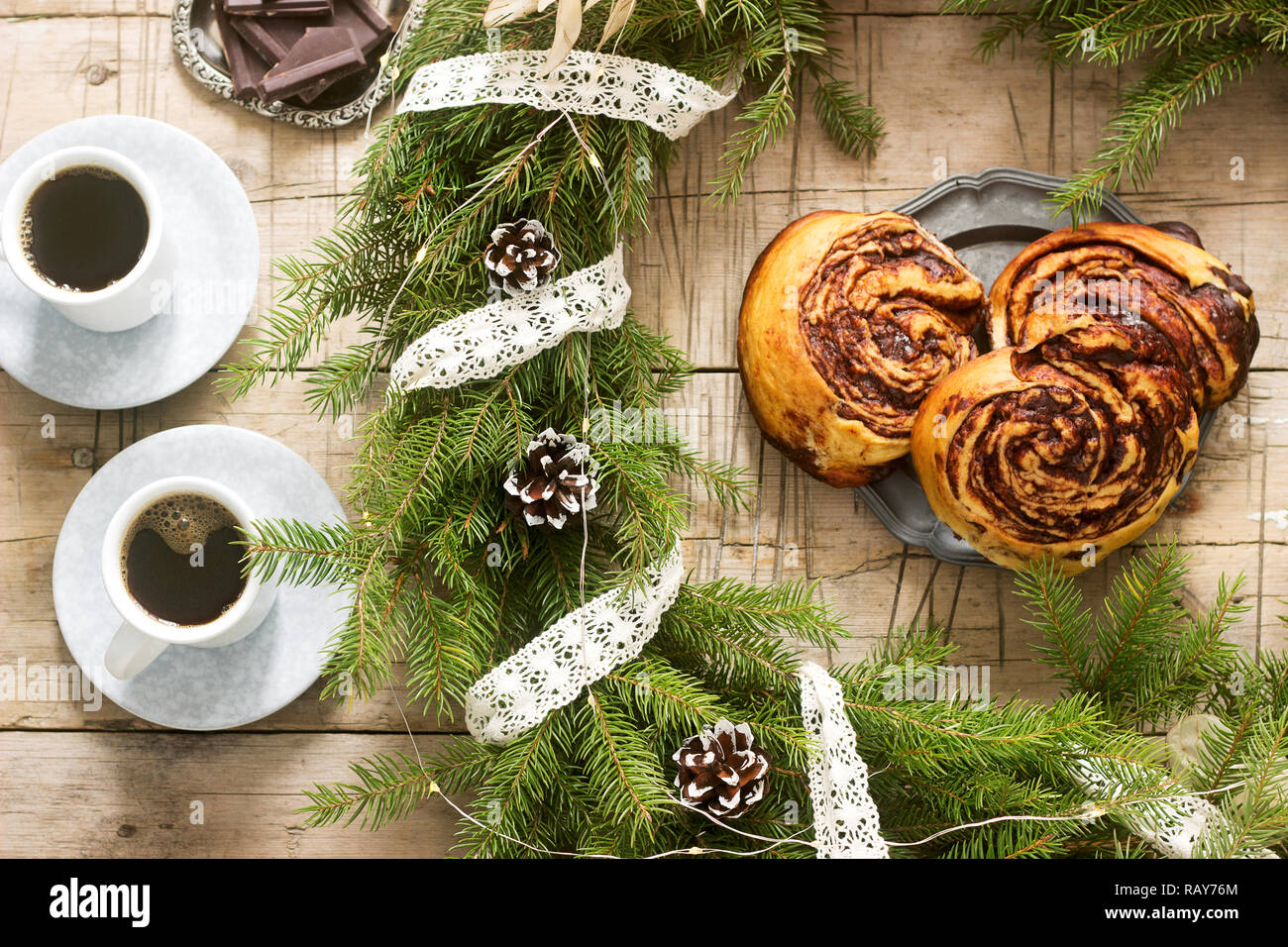 Snail chocolate muffins served with coffee on the background of a