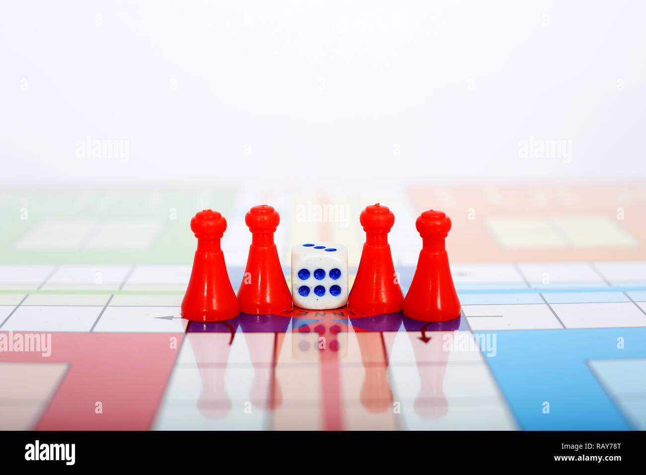 Portrait of red pawns with dice on the ludo game. Stock Photo