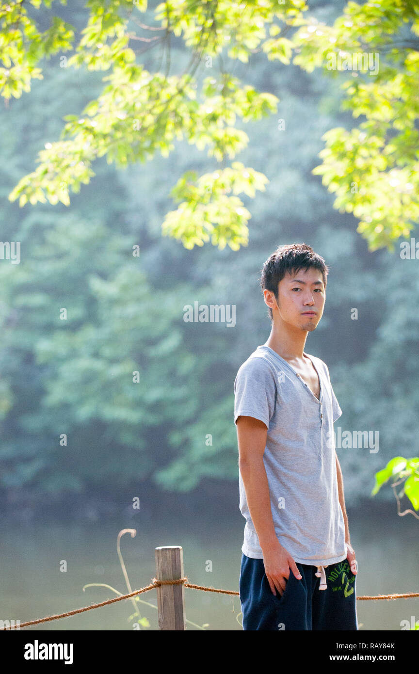 Asian male model poses for pictures on the street Stock Photo - Alamy