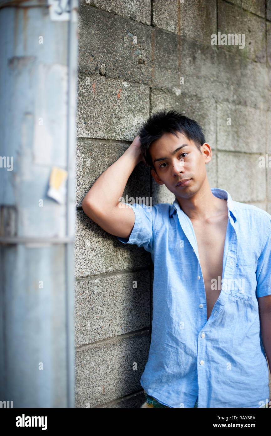 Asian male model poses for pictures on the street Stock Photo - Alamy