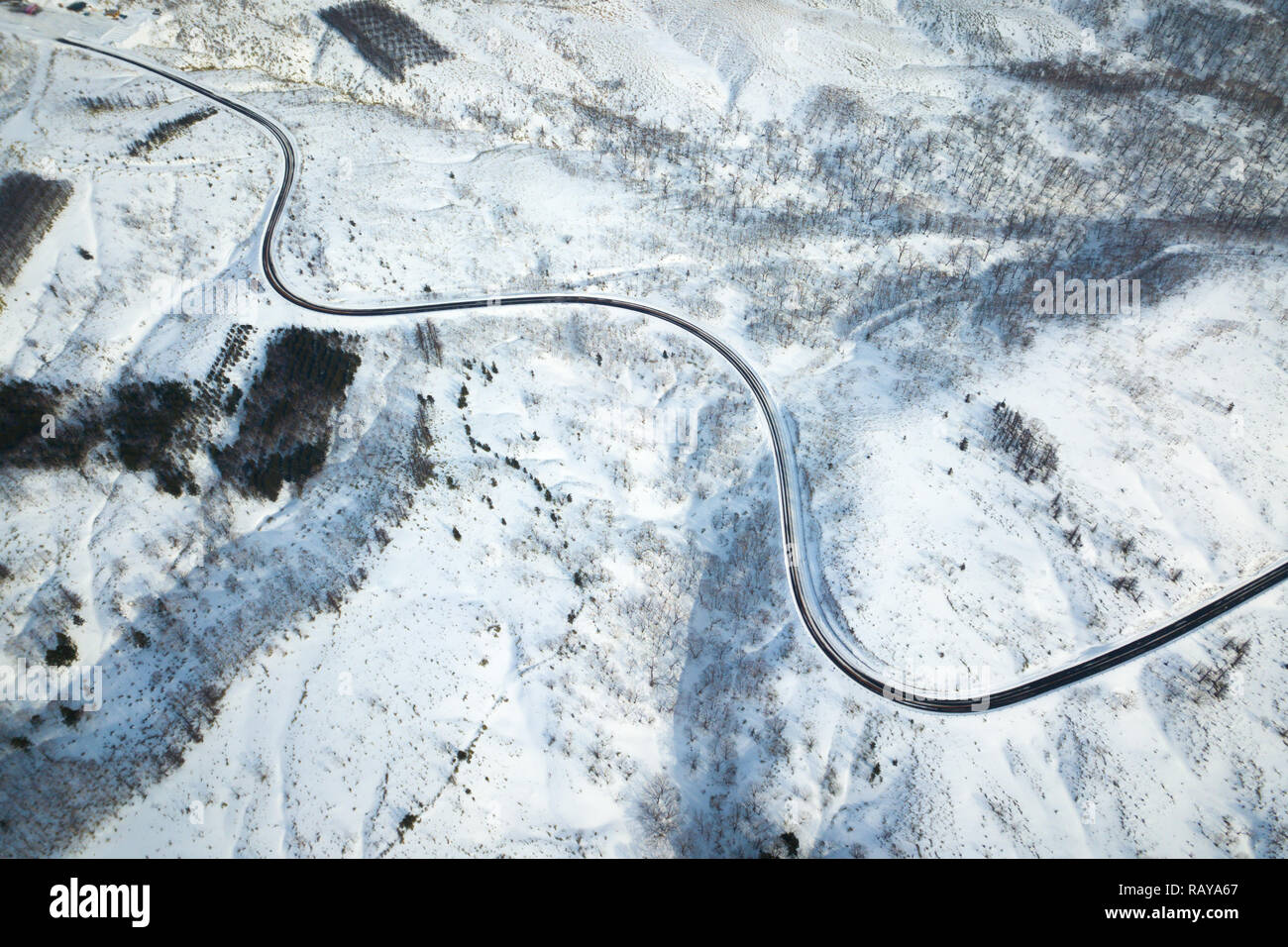 curved road on the mountains in hokkaido Stock Photo