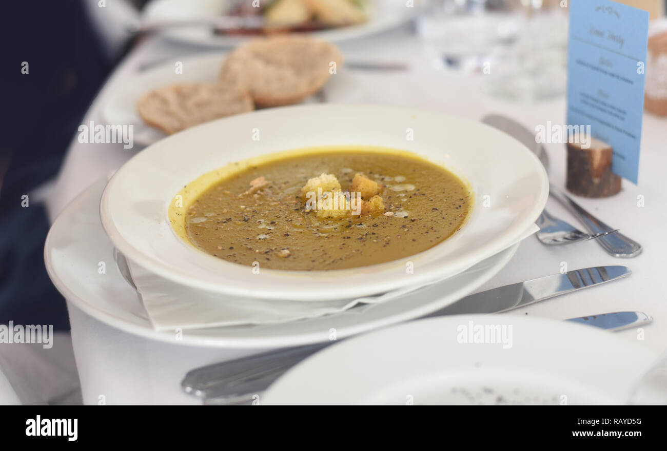 Fine dining vegetable soup starter well presented a la carte meal in a table setting Stock Photo