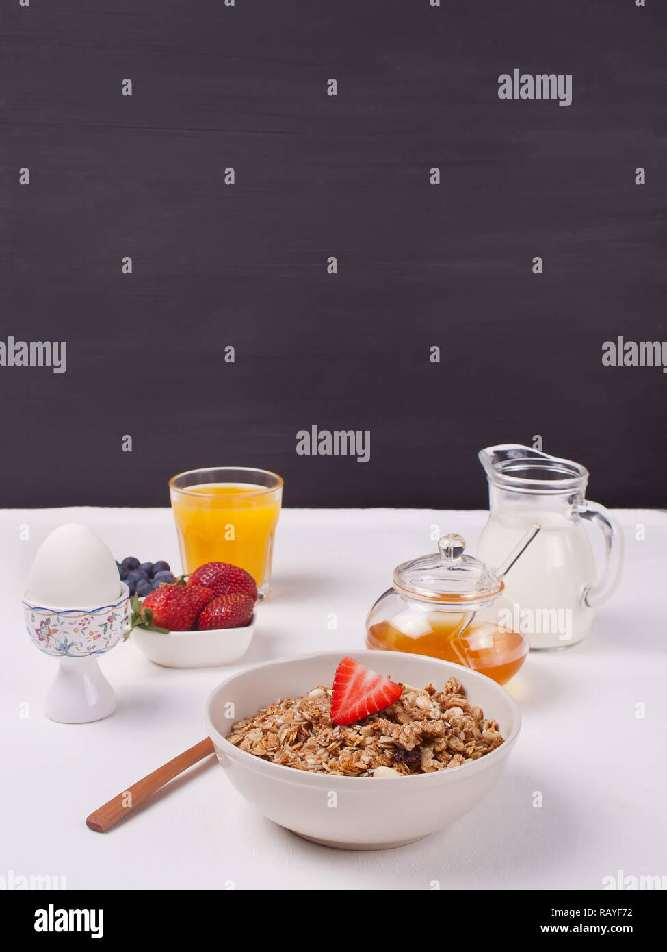 Breakfast with muesli, strawberries, juice, milk on a white background ...