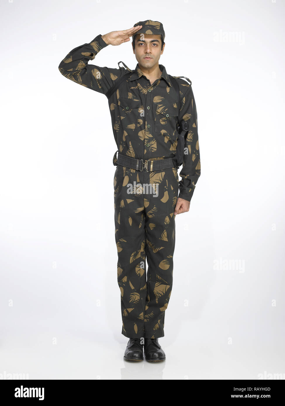 PORTRAIT OF INDIAN SOLDIER DRESSED IN UNIFORM  SALUTING Stock Photo