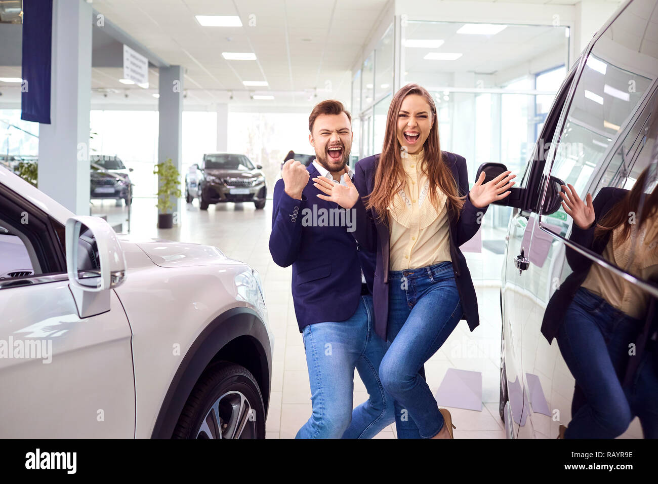 Car buyers are happy to buy a car in the auto salon Stock Photo