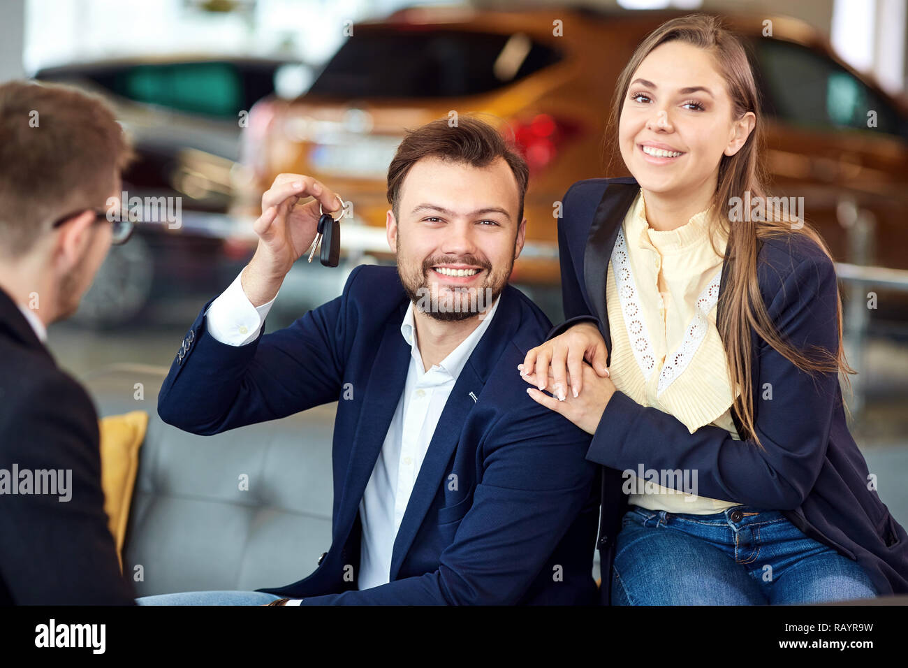 The dealer gives the keys to the new car to the customer Stock Photo