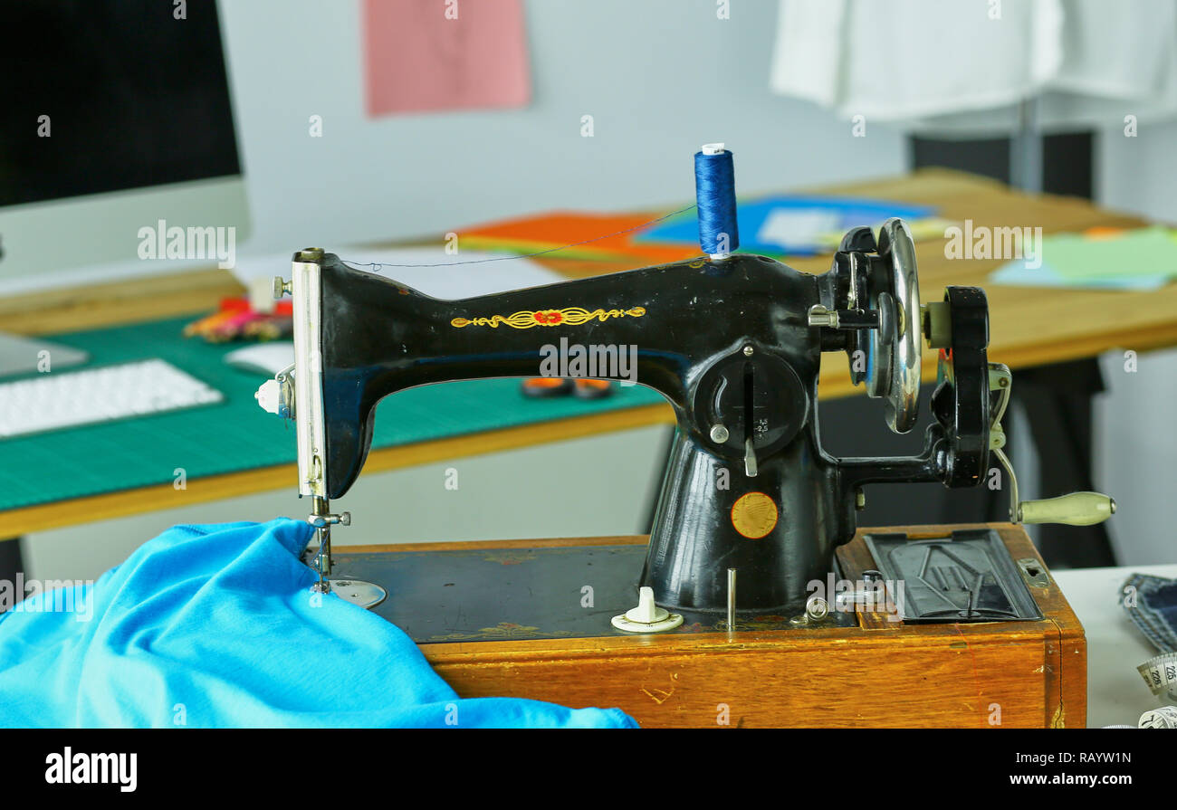 Retro sewing machine on designer clothes desktop Stock Photo - Alamy