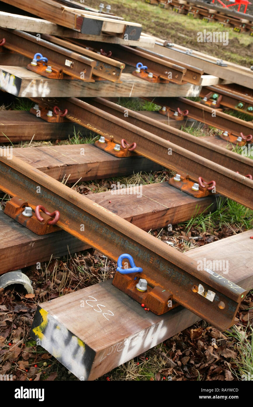 Sections of new rail track awaiting laying. Stock Photo