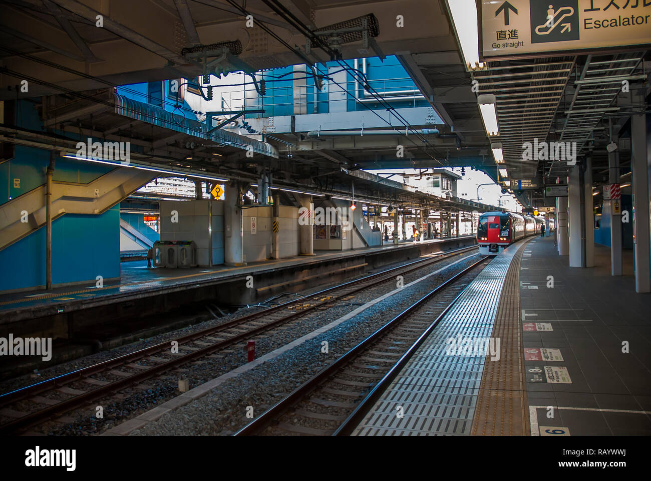 Train arriving on a platform of JR train station in Kamakura Stock Photo