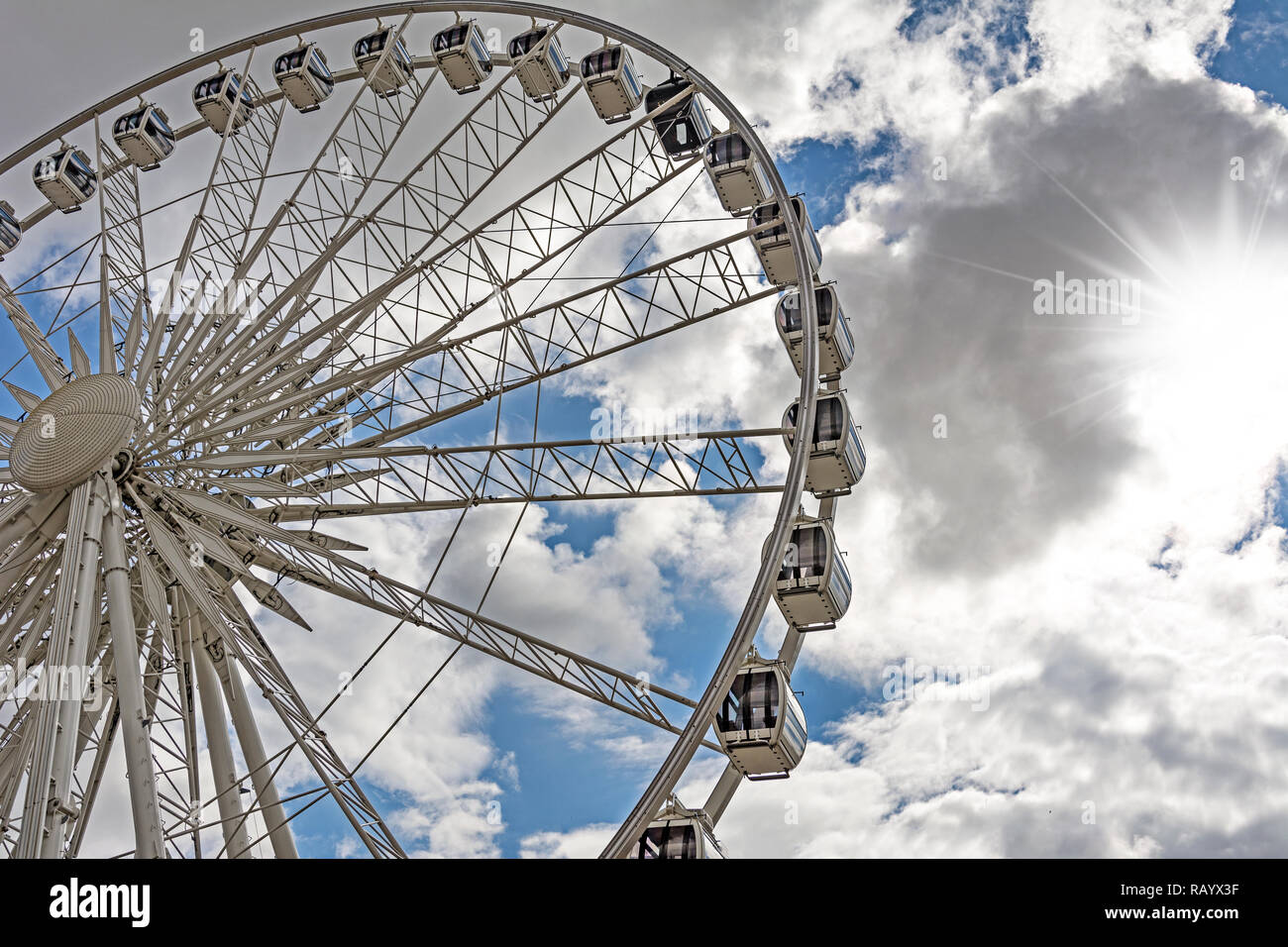 Part of a big ferris wheel on a cloudy sky background Stock Photo - Alamy