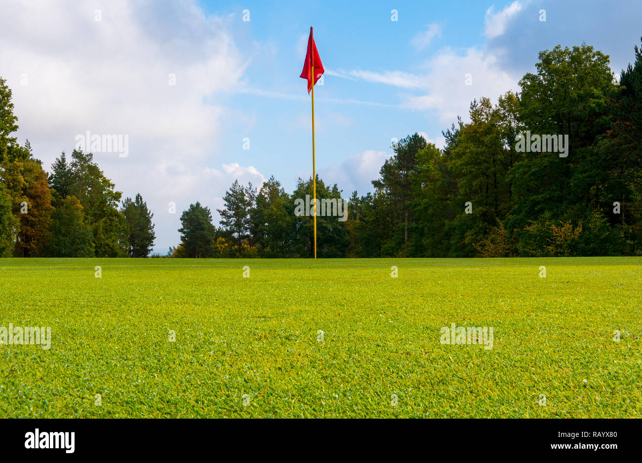 red flag placed on golf course Stock Photo