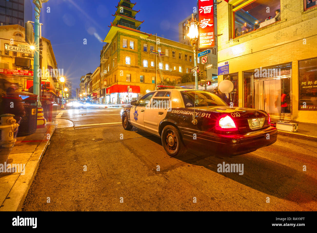 San Francisco, California, United States - August 16, 2016: police car on a street in Chinatown of San Francisco by night. Urban street view. Blue hour shot. Stock Photo