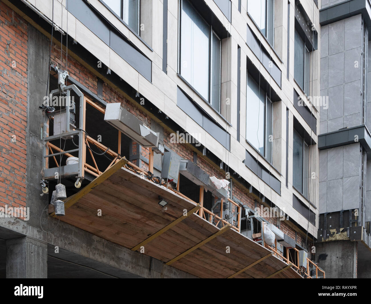 construction site cradle on a skyscraper for renewval repair Stock Photo