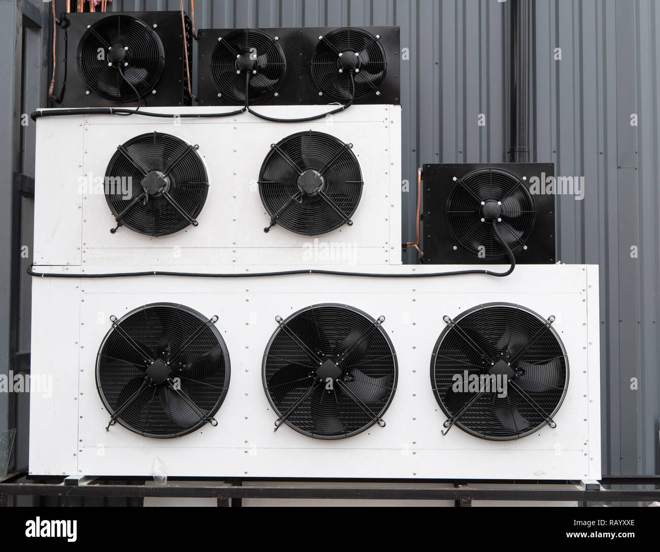 closeup photo of wall filled with rows of industrial air conditioner