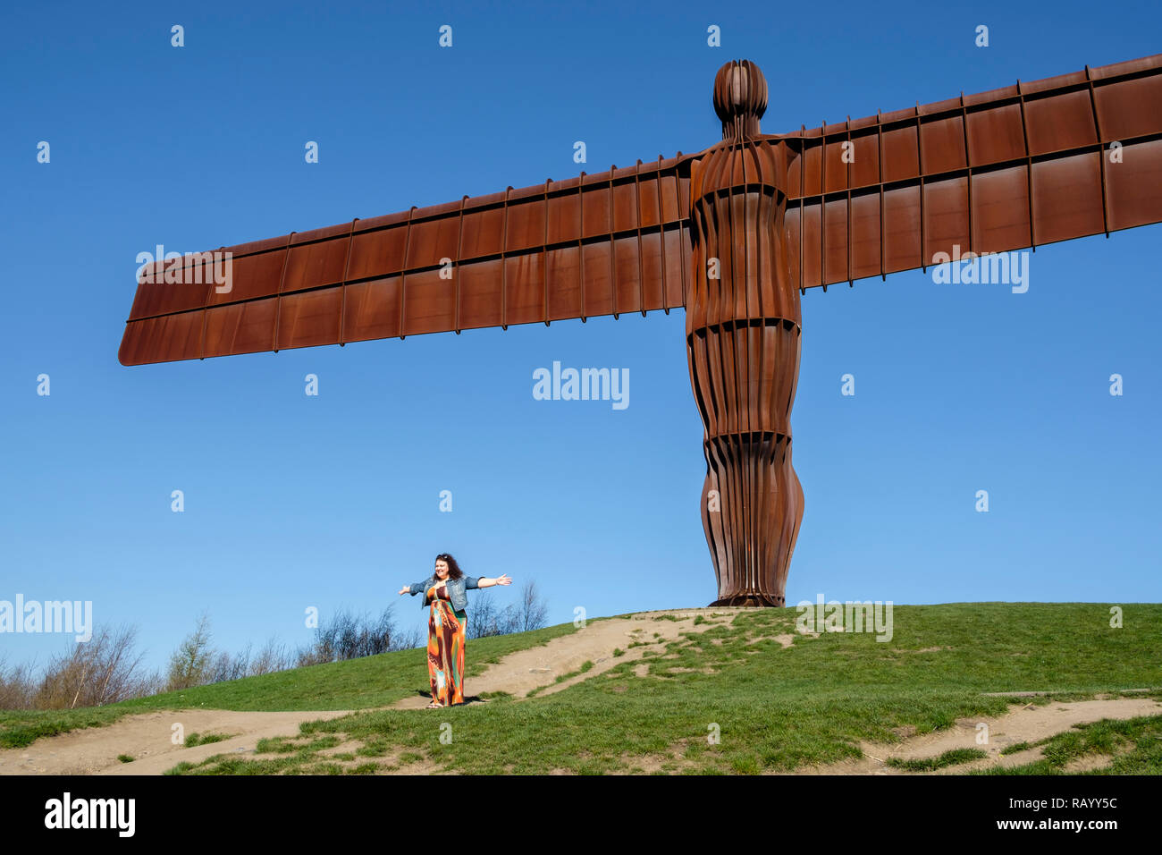 Posing for photos by the Angel of the North, Gateshead, Tyne and Wear, England Stock Photo
