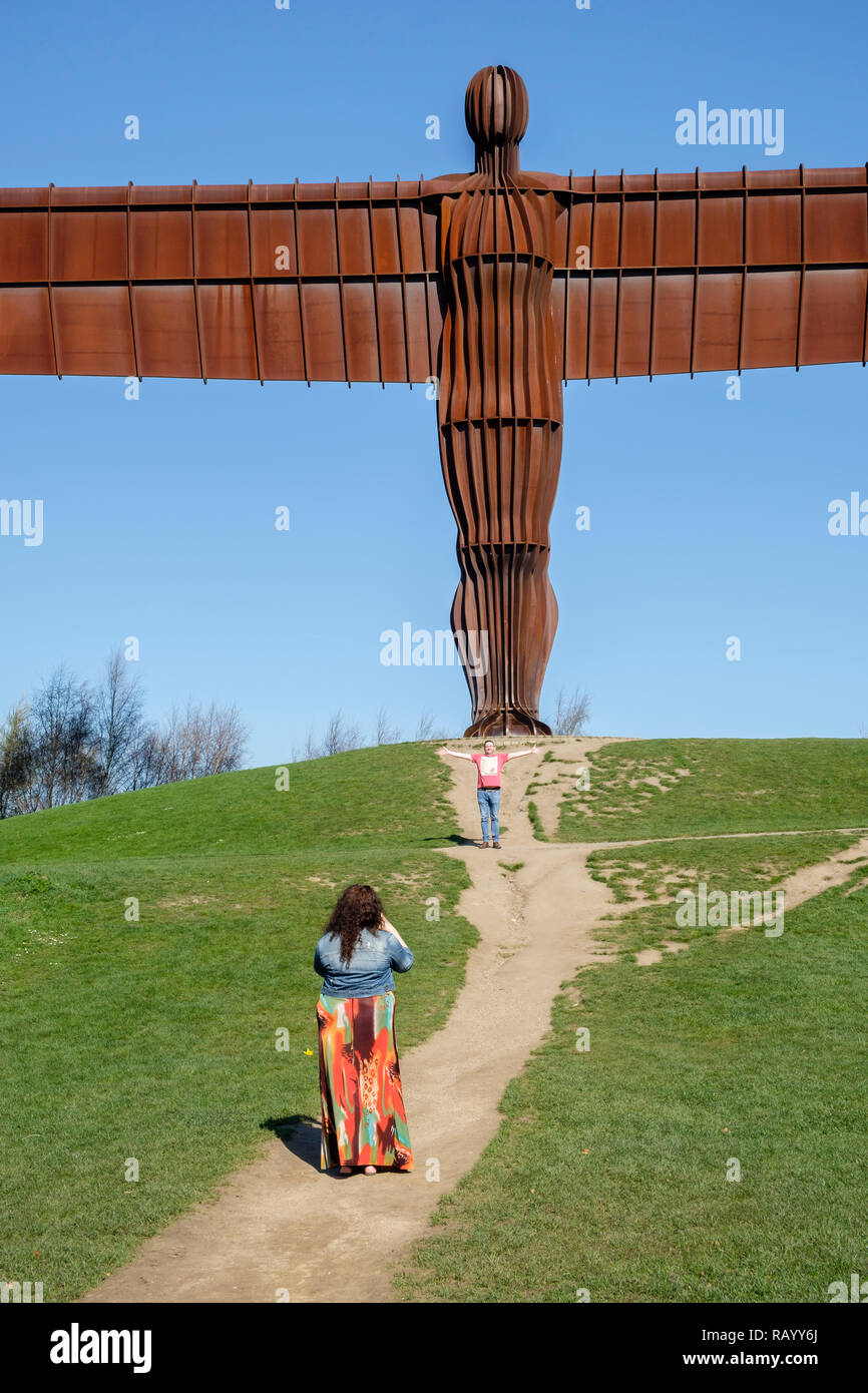 Posing for photos by the Angel of the North, Gateshead, Tyne and Wear, England Stock Photo