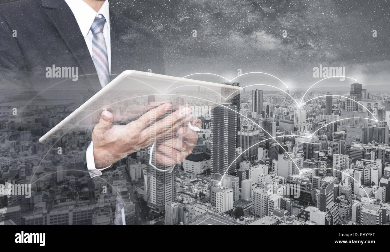 Double exposure businessman using digital tablet, and cityscape. Business network, blockchain technology and internet connection Stock Photo