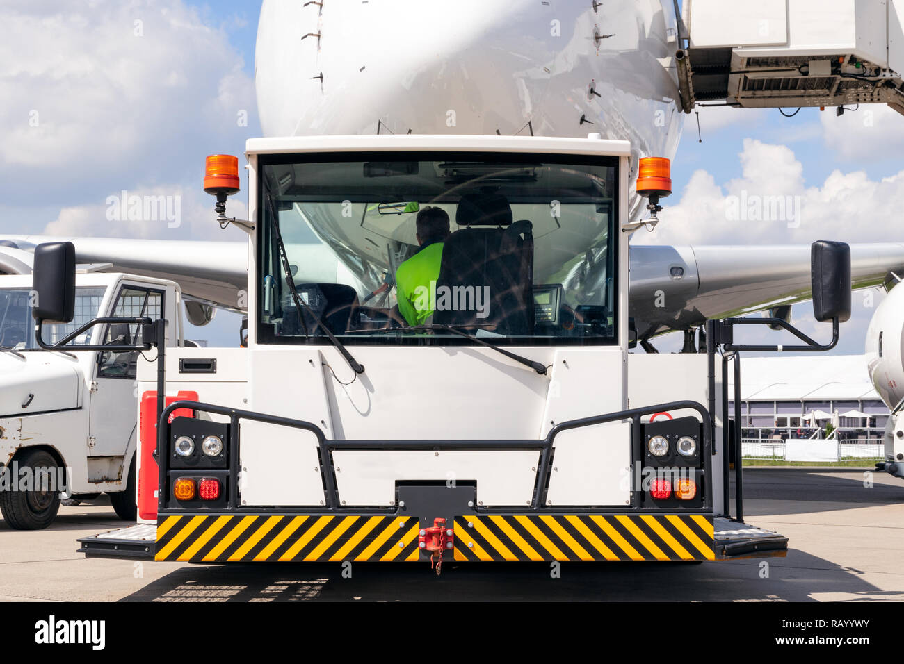 passenger plane about to be towed by an airport towing vehicle on the