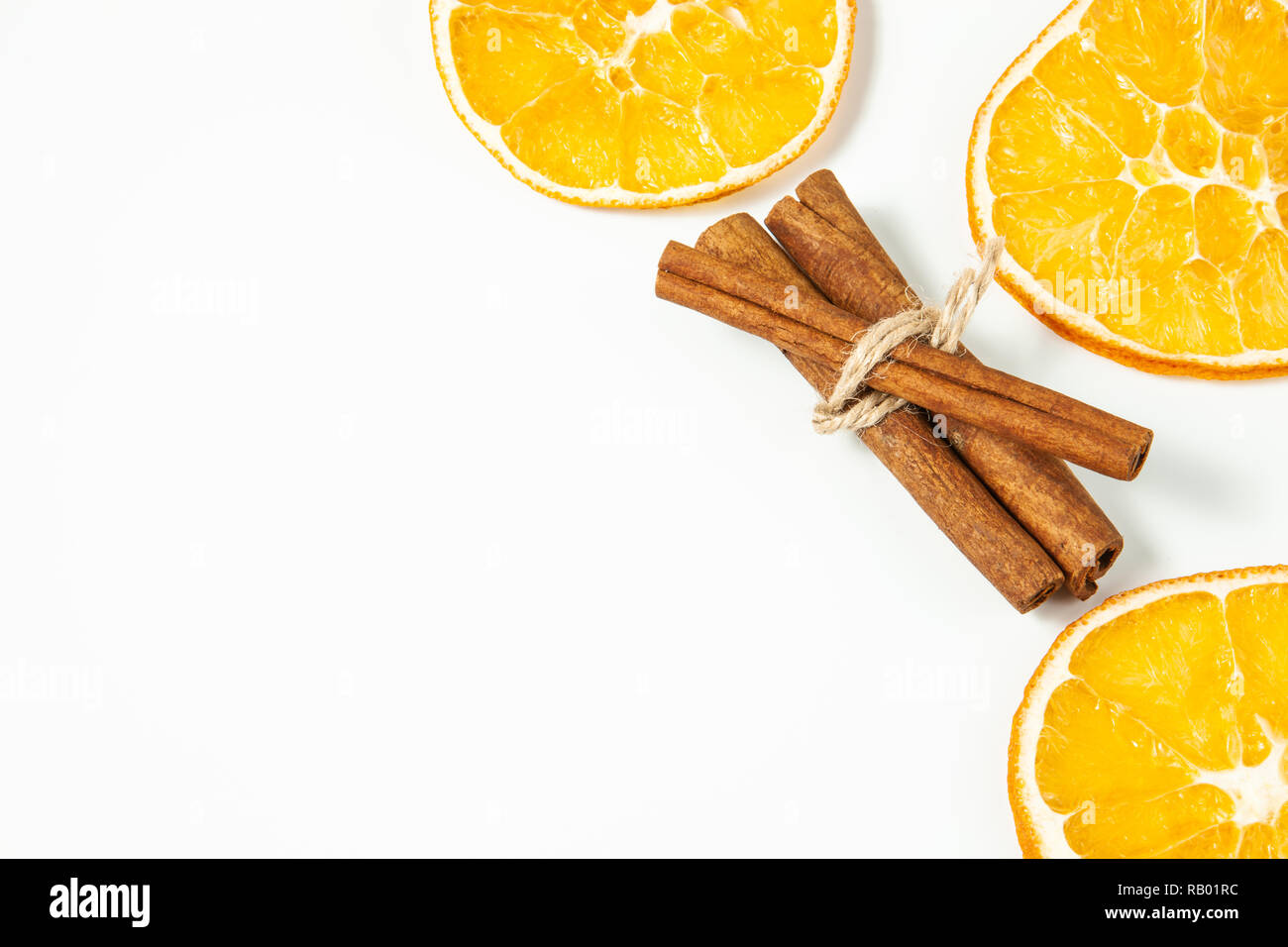 Top view, Orange slice and cinnamon sticks on a white background, space for text Stock Photo