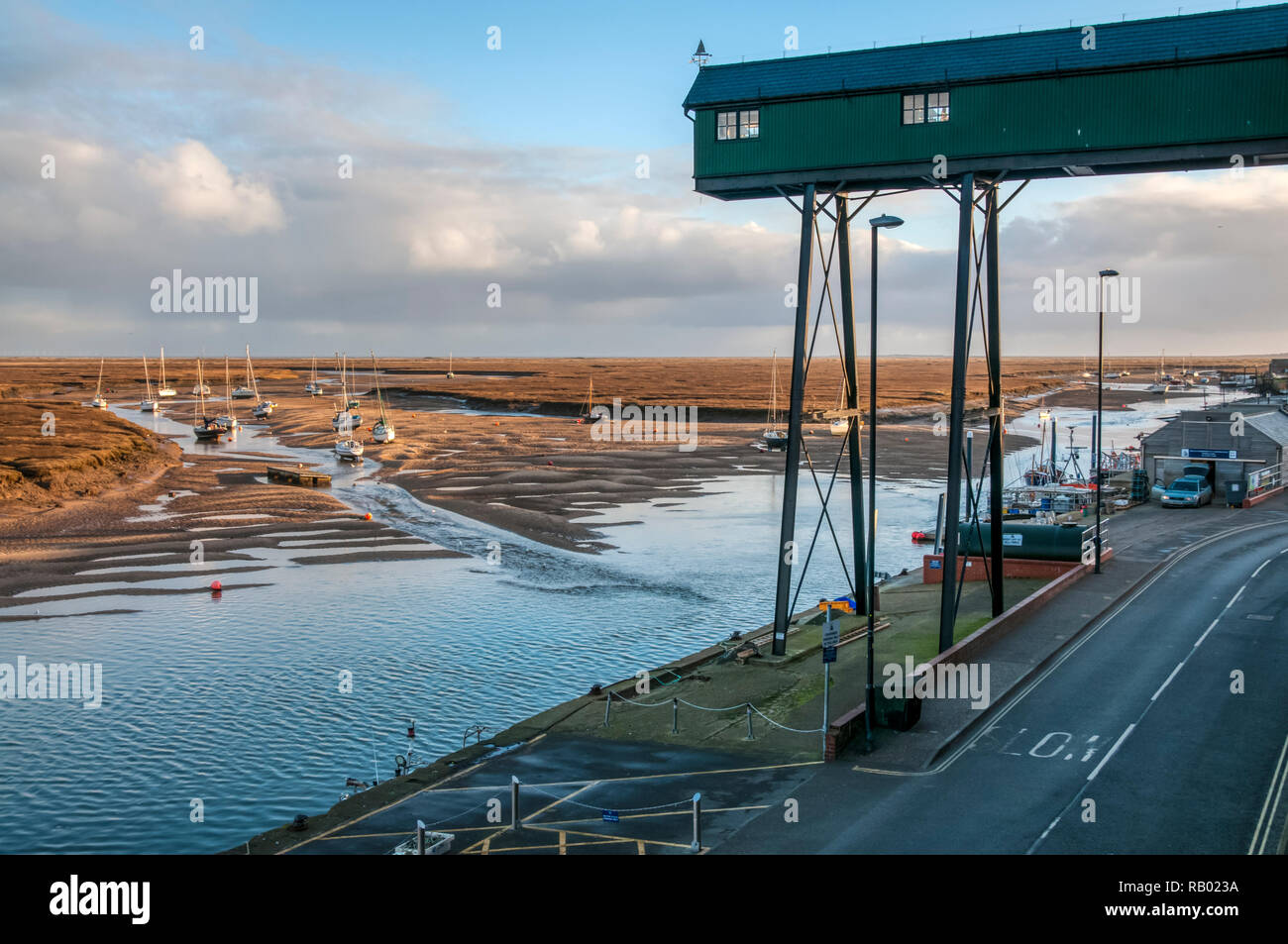 The quay at Wells-next-the-Sea behind the salt marshes on the north Norfolk coast. Stock Photo