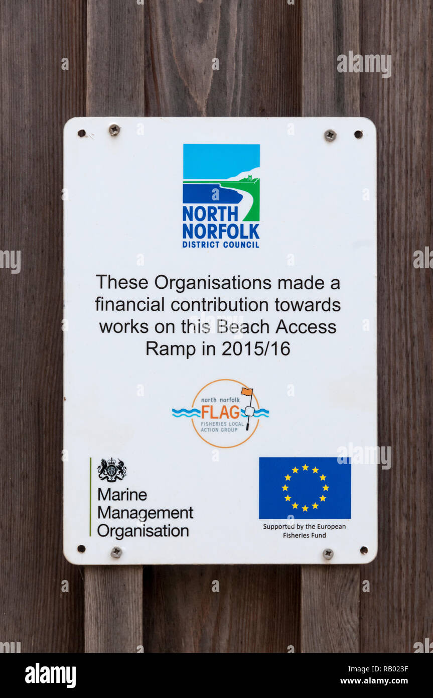 A plaque in Sheringham, North Norfolk, records the contribution of the European Fisheries Fund to the provision of a beach access ramp. Stock Photo