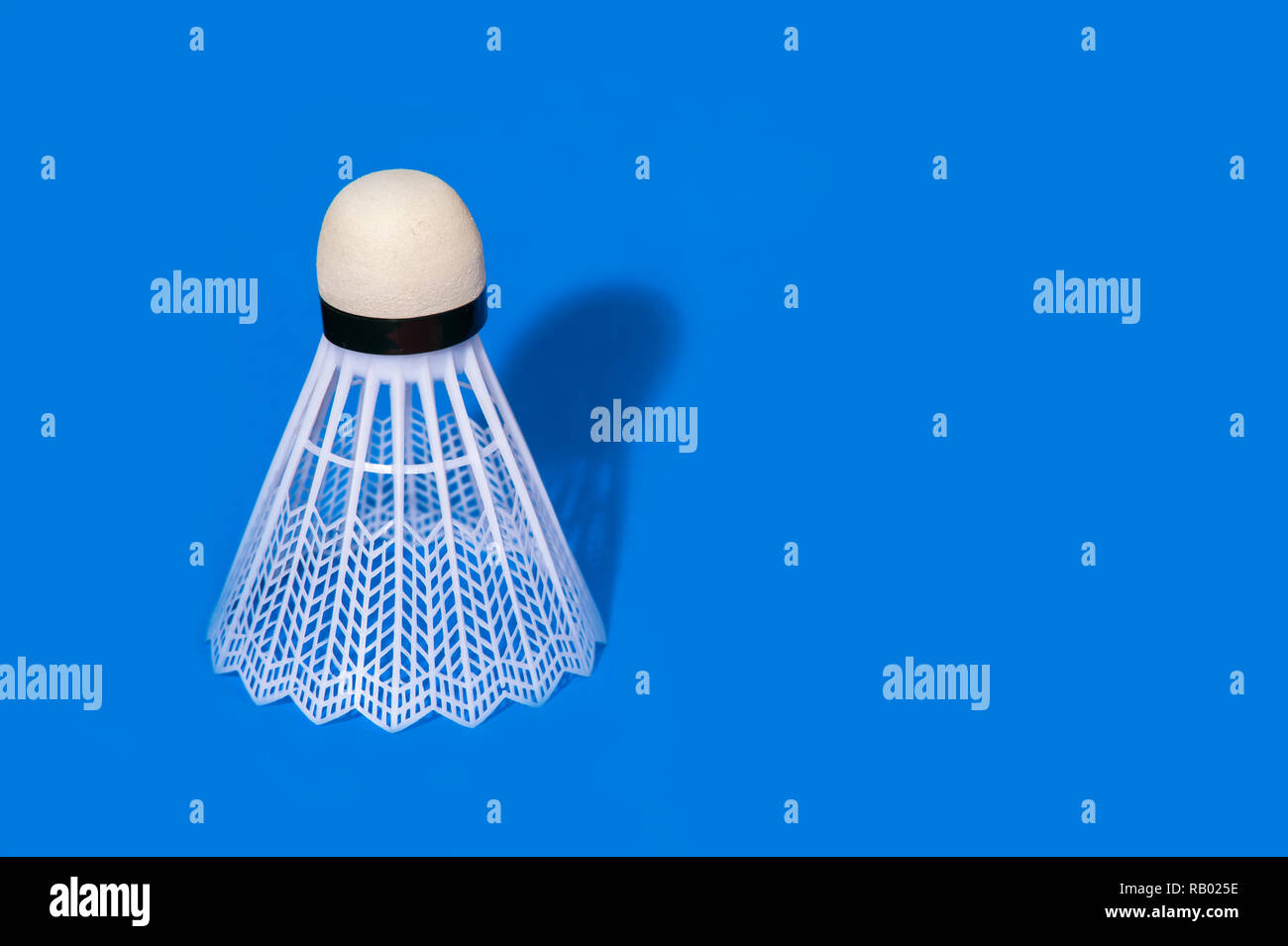 Badminton shuttlecock isolated on the blue background Stock Photo