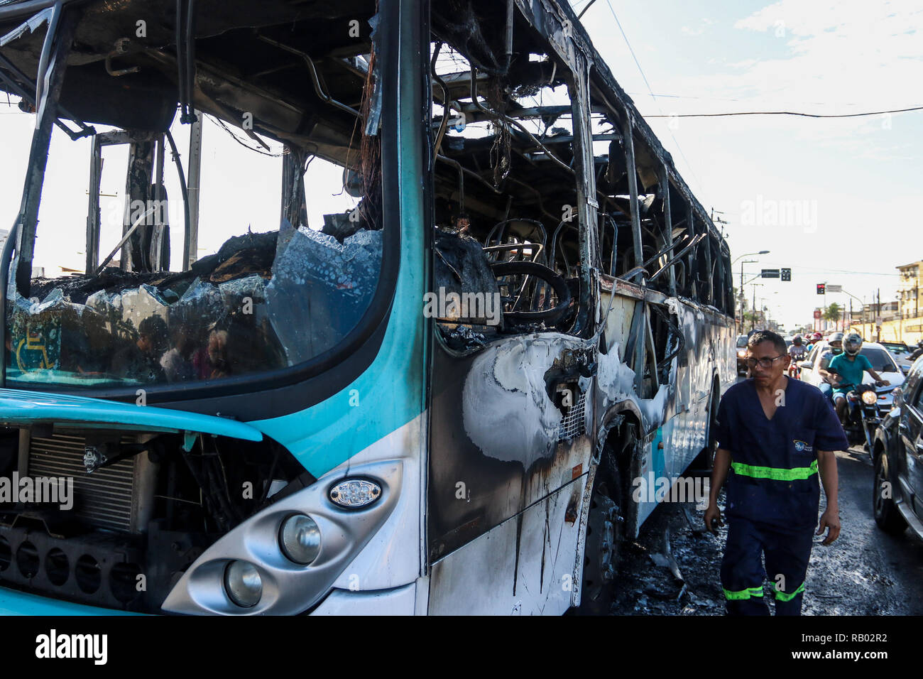 Fortaleza, Brazil. 04th Jan, 2019. A man walks past a burnt-out bus after an attack in Fortaleza. The newly inaugurated Brazilian government has sent military police to the state of Ceara after a series of attacks in the past two days on banks, public buildings and infrastructure in 15 cities. Credit: Alex Gomes/dpa/Alamy Live News Stock Photo