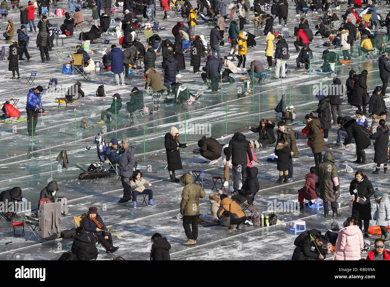 Hwacheon, South Korea. 5th Jan, 2019. January 5, 2019-Hwacheon, South Korea-Visitors cast lines through holes drilled in the surface of a frozen river during a trout catching contest in Hwacheon, South Korea. The contest is part of an annual ice festival which draws over one million visitors every year. Credit: Ryu Seung-Il/ZUMA Wire/Alamy Live News Stock Photo