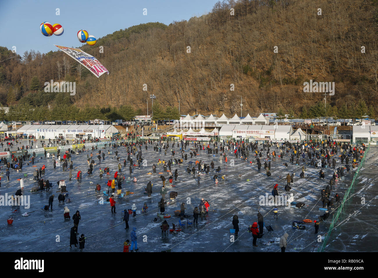 Hwacheon, South Korea. 5th Jan, 2019. January 5, 2019-Hwacheon, South Korea-Visitors cast lines through holes drilled in the surface of a frozen river during a trout catching contest in Hwacheon, South Korea. The contest is part of an annual ice festival which draws over one million visitors every year. Credit: Ryu Seung-Il/ZUMA Wire/Alamy Live News Stock Photo