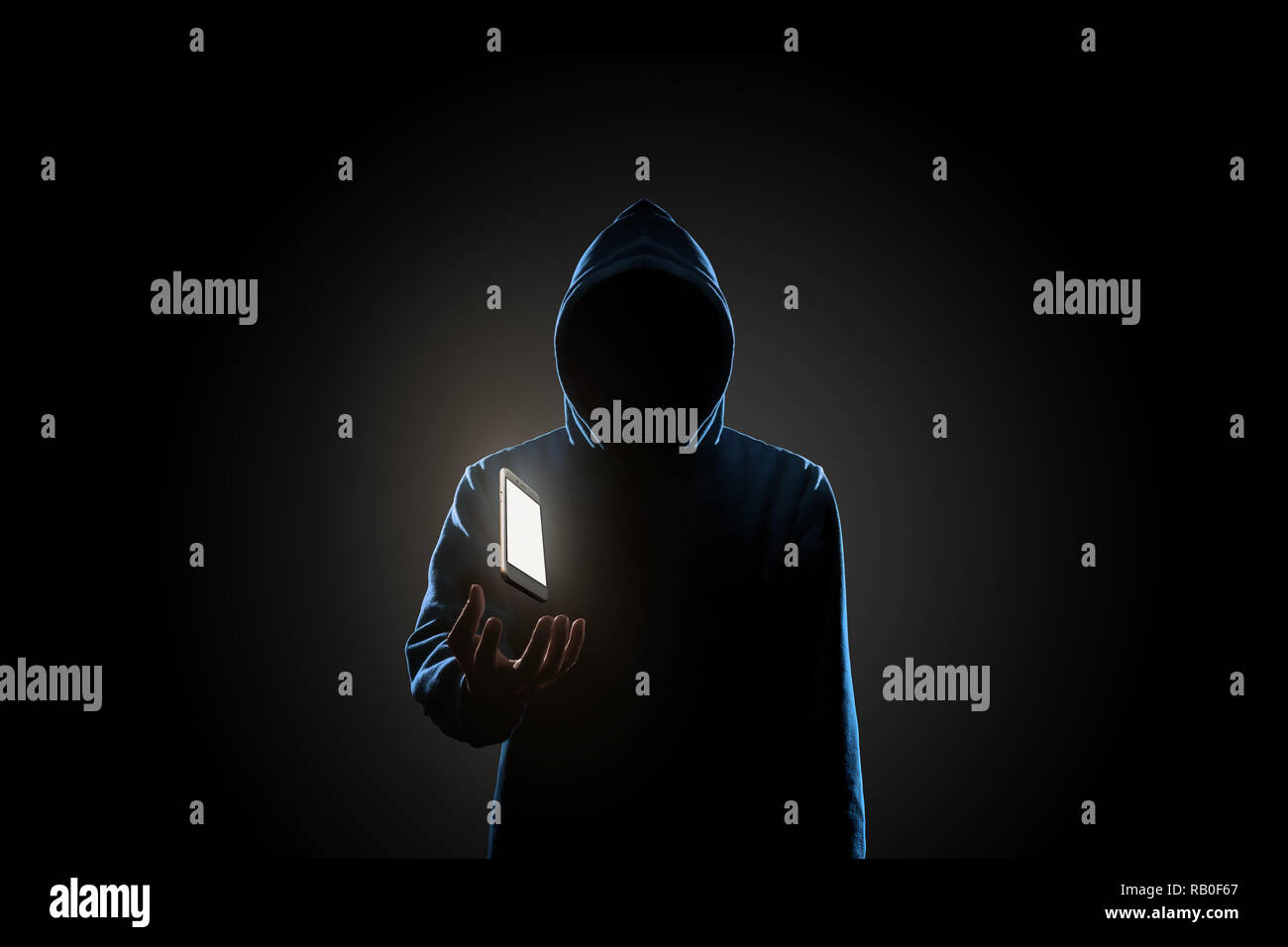 White smartphone floating above of hacker's hand in dark background. Finance, business, e-commerce or cyber crime concept Stock Photo