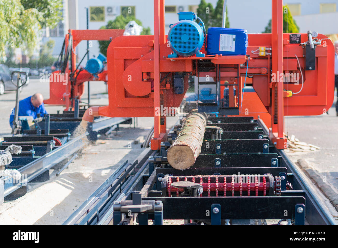 Partially milled log on a portable lumber milling machine Stock Photo