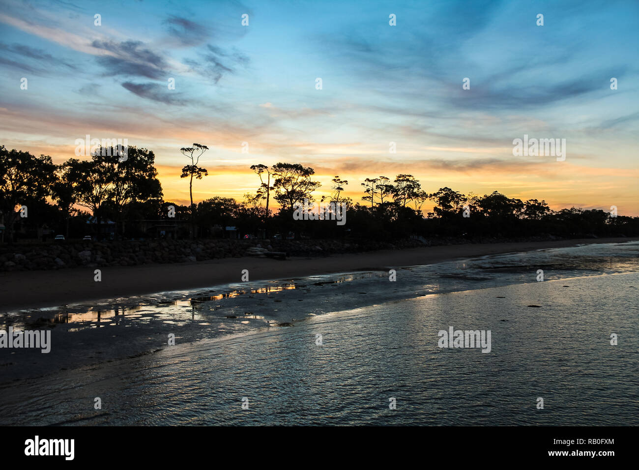 Spectacular sunset at Hervey Bay beach during low tide with colourful cloud formations (Hervey
