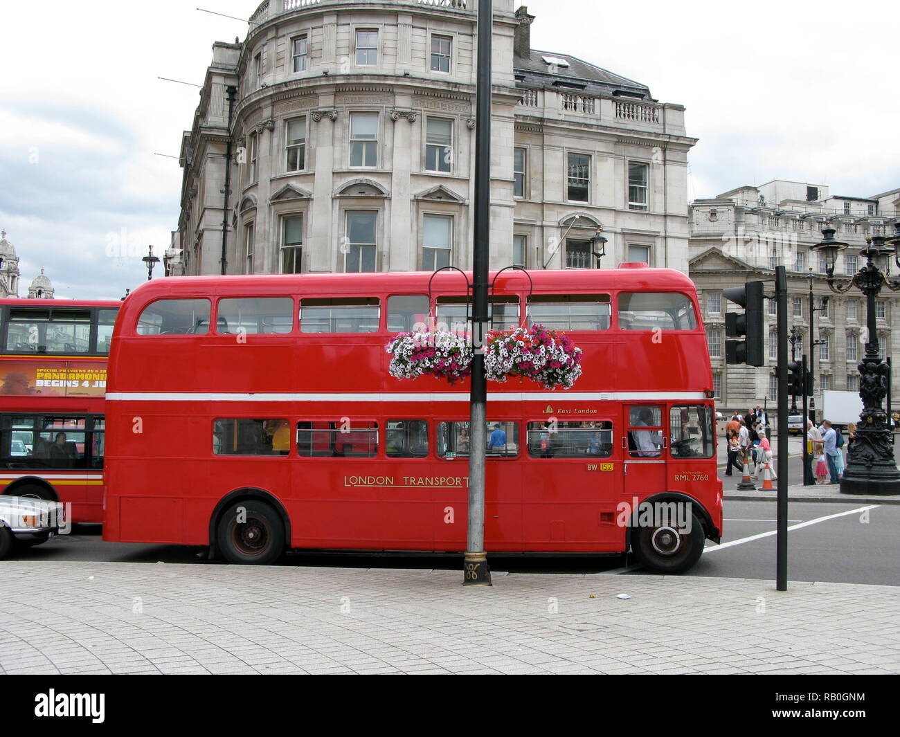 London red double decker bus in Trafalgar Square in summer in busy traffic. London transport. Stock Photo