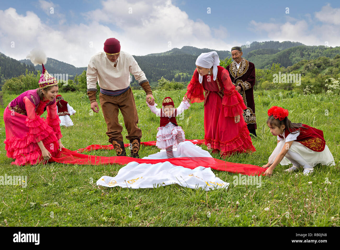 Kazakh people showing local tradition of Tusau Kesu which symbolizes a ceremony that accompanies first steps of a child, Kazakhstan Stock Photo