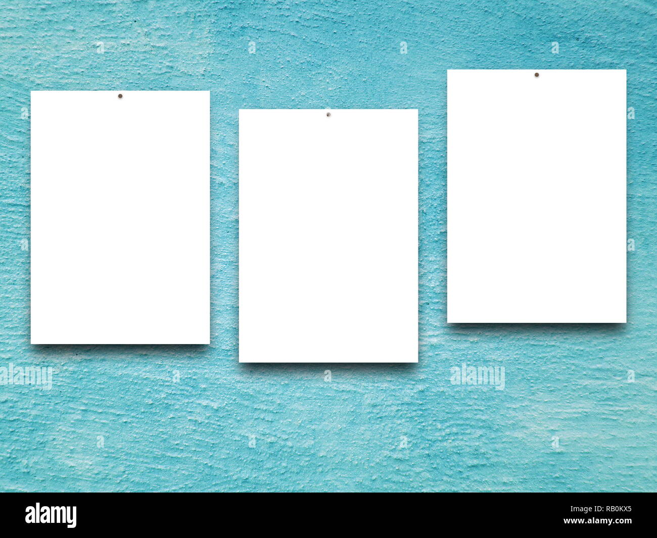 Three blank frames on aqua plaster wall background Stock Photo