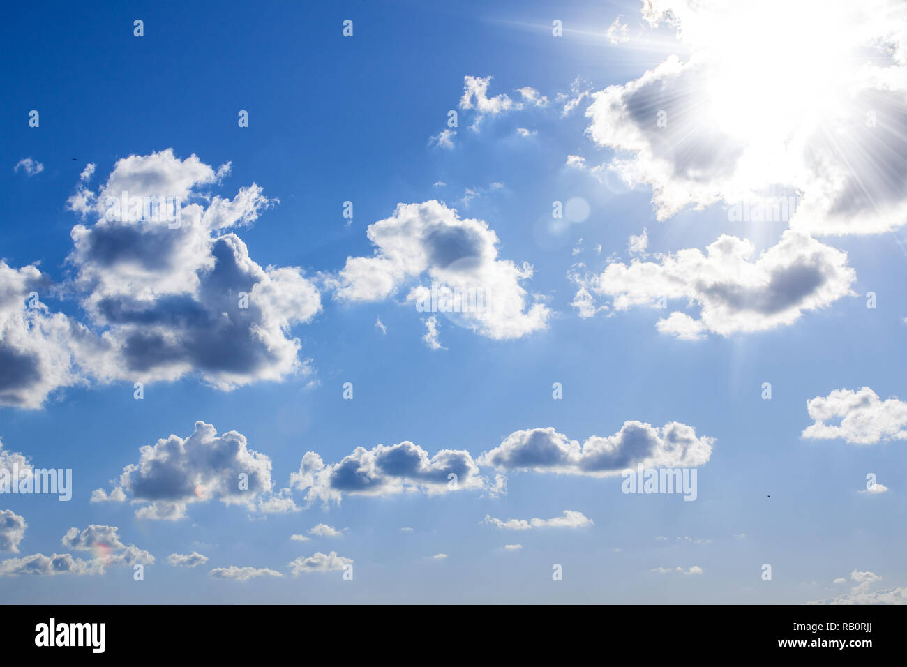 blue sky with sunbeams and clouds. Stock Photo