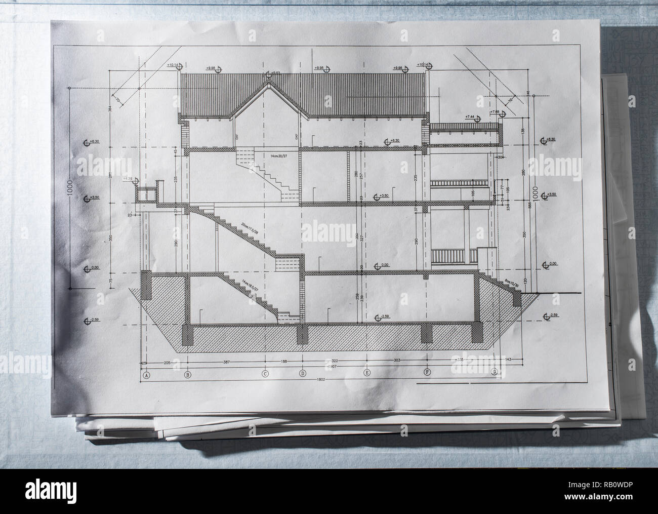 Home design blueprint. Sketches of a house project. Construction background. Technical architectural project house plan. Many papers on the architect  Stock Photo