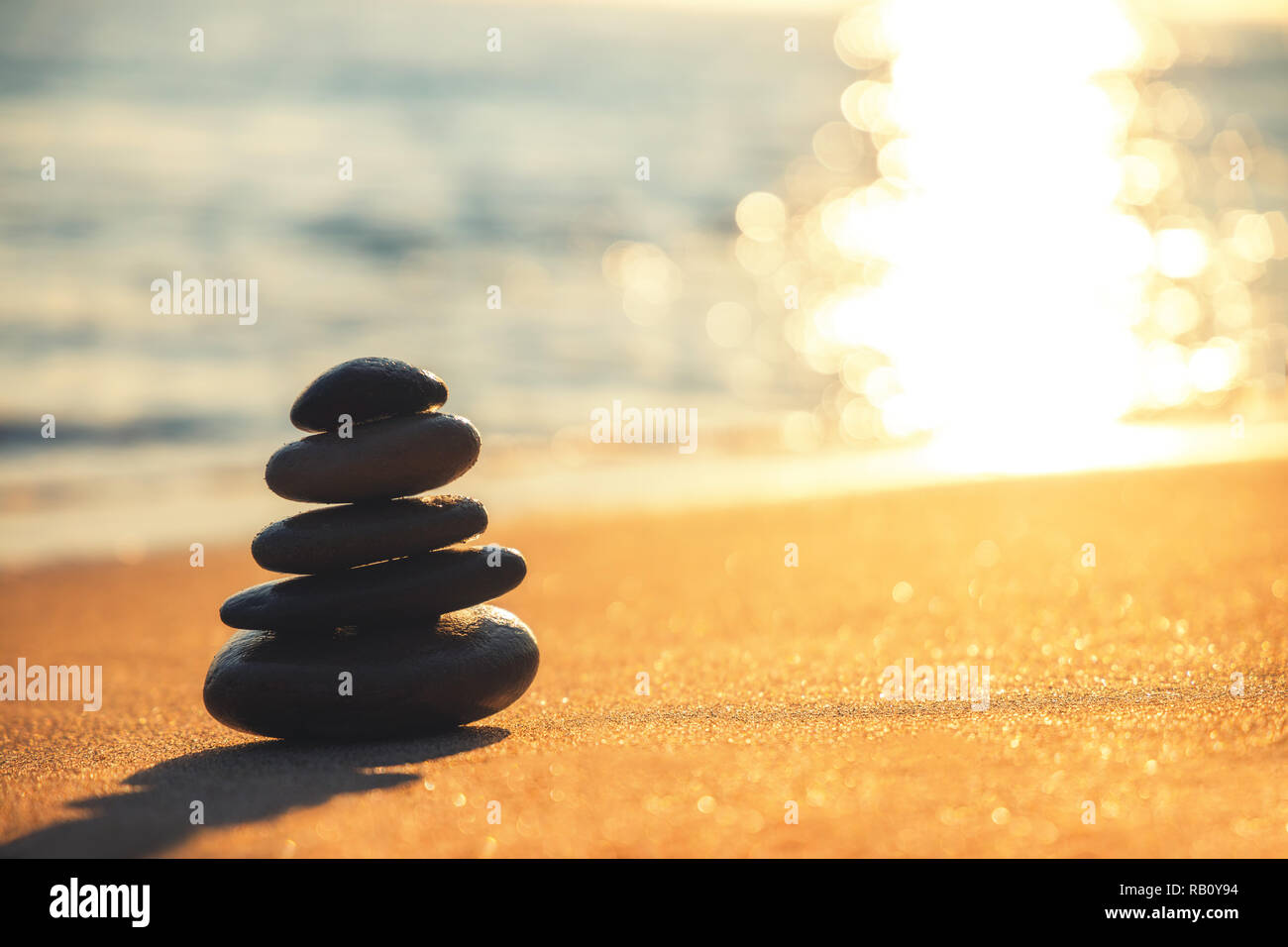 Stones balance on beach, sunrise shot. Zen meditation. Yoga practice. Stock Photo