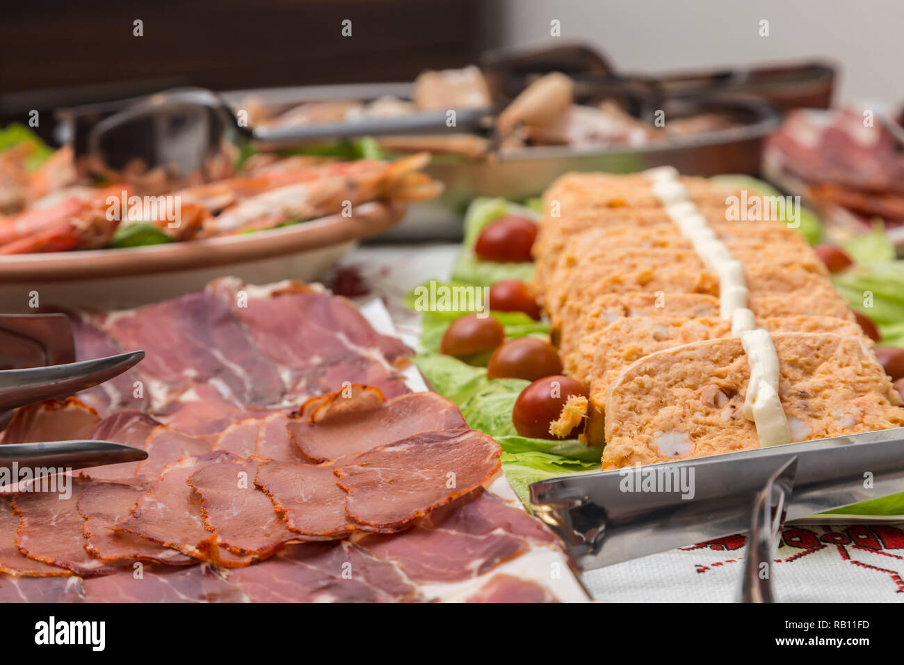 trays with different plates of food, meat, cold meats, fish cake ...