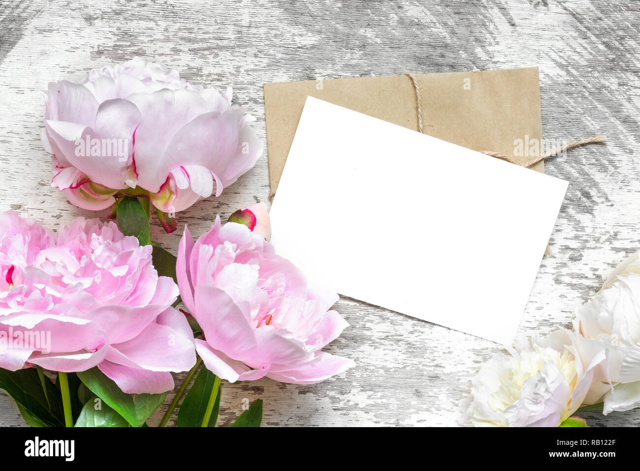 blank white greeting card with pink peony flowers bouquet and envelope ...