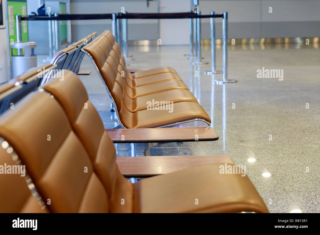 Empty seats bench in the airport hall departure gate at international