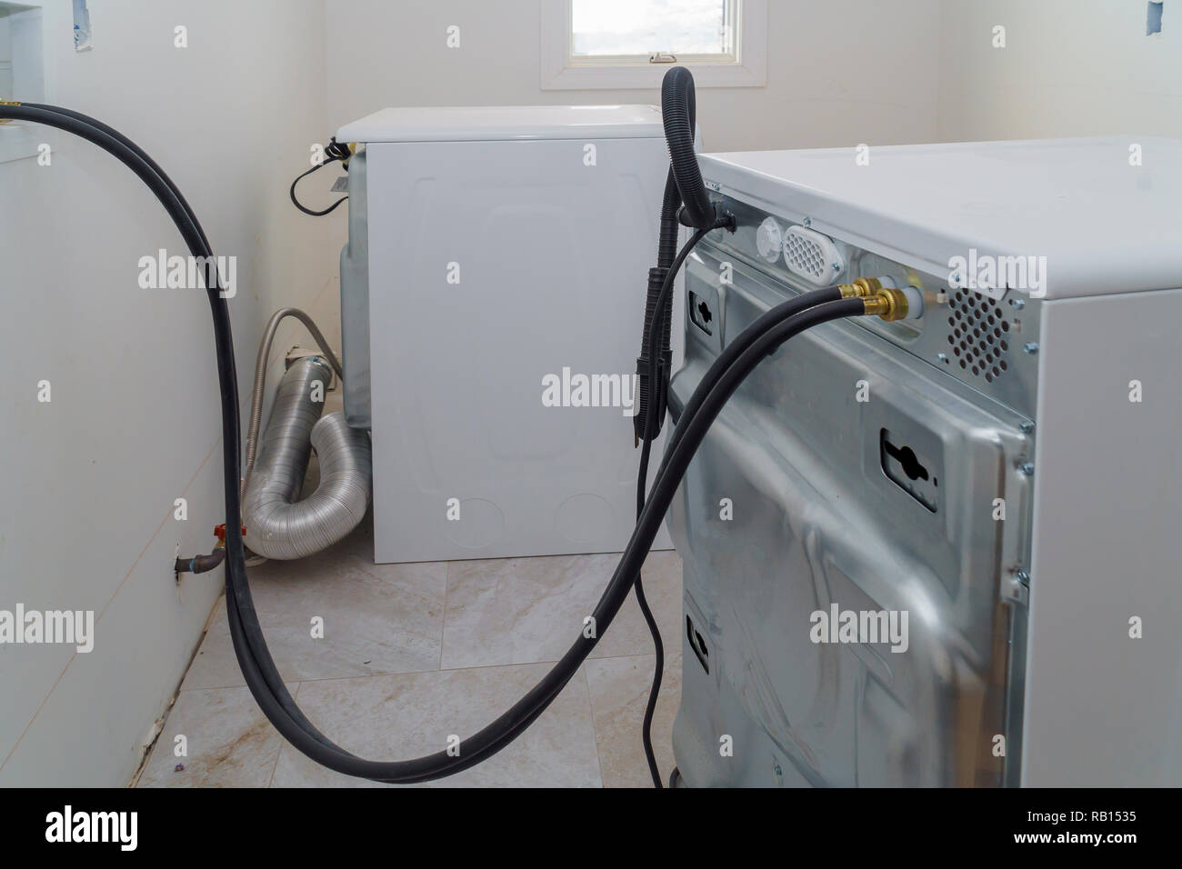 Installation Hoses for to washing machine bathroom and laundromat Stock