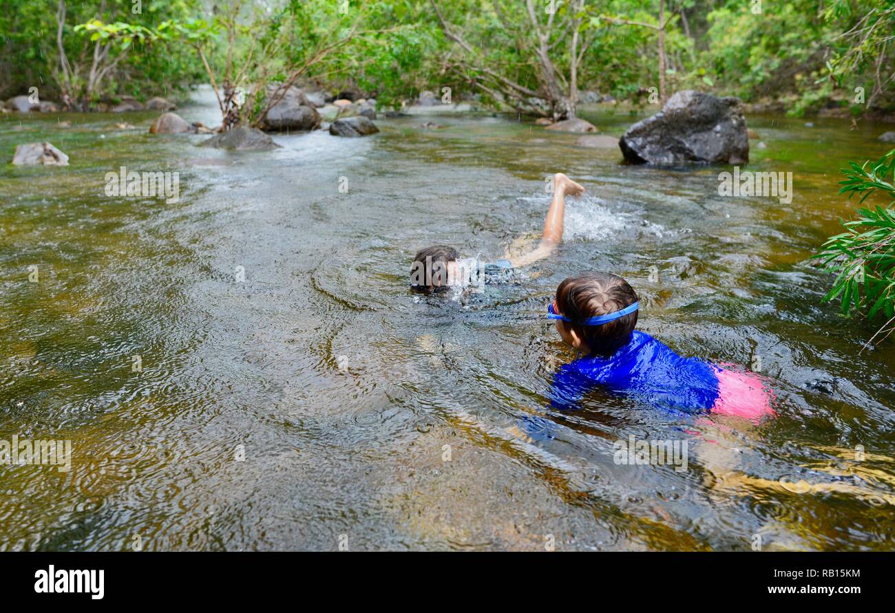 A family swimming in a stream, Alligator Creek, Townsville, Qld, Australia Stock Photo